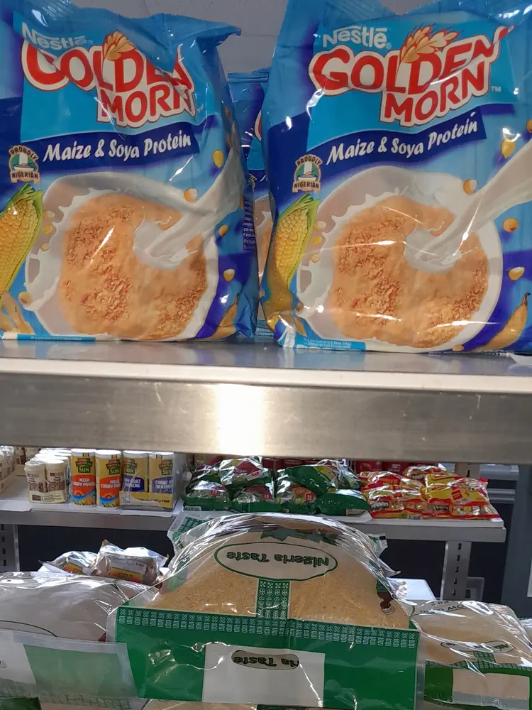 Shelf of Nestlé Golden Morn, garri and Indomie noodle packets