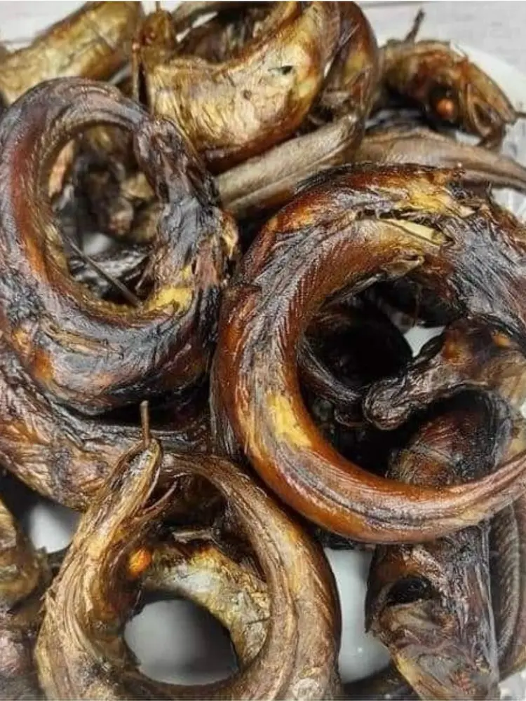 Plate piled with curled dried smoked fish